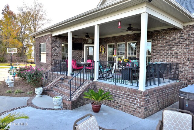 doorway to property with ceiling fan and a porch