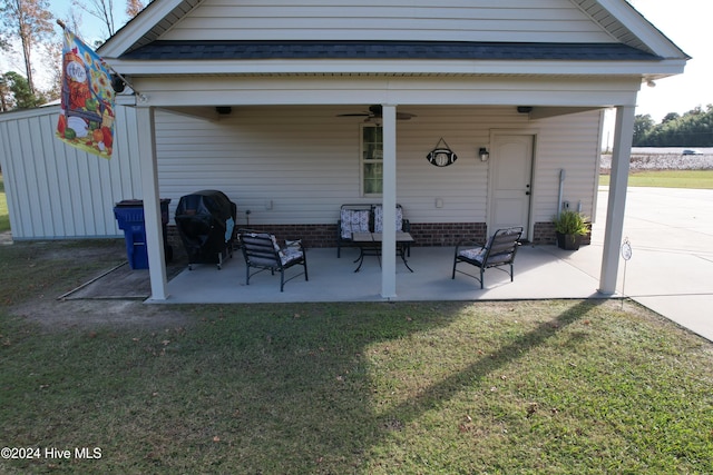 rear view of property with a yard, a patio, and ceiling fan