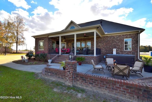 rear view of house with a hot tub, a patio, ceiling fan, and covered porch