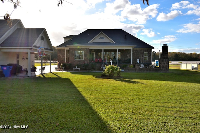 rear view of house with a yard