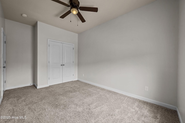 unfurnished bedroom featuring carpet, a closet, and ceiling fan