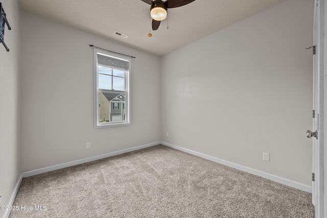 carpeted empty room featuring ceiling fan