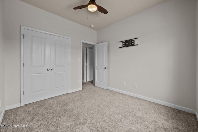 unfurnished bedroom with light carpet, a closet, and ceiling fan