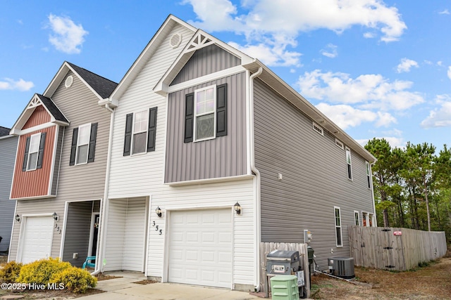 view of front facade featuring a garage and central AC