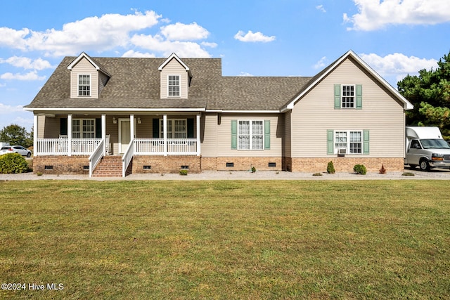 new england style home featuring a front lawn and covered porch