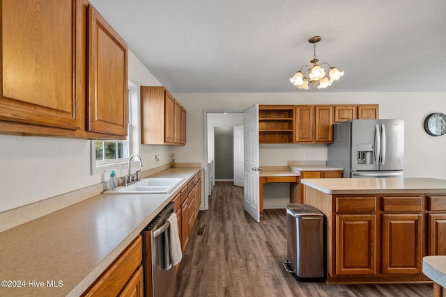 kitchen with sink, appliances with stainless steel finishes, dark hardwood / wood-style floors, decorative light fixtures, and a chandelier