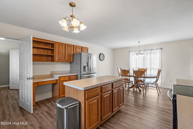 kitchen featuring appliances with stainless steel finishes, dark hardwood / wood-style flooring, pendant lighting, a chandelier, and a center island