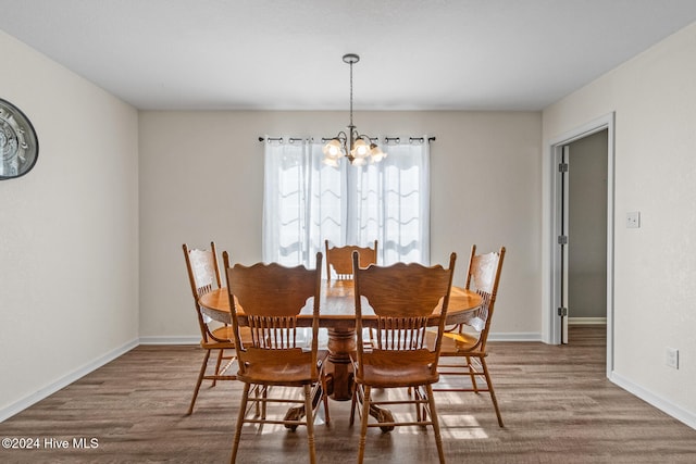 dining room with an inviting chandelier and hardwood / wood-style flooring