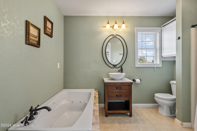 bathroom featuring toilet, a washtub, vanity, and tile patterned flooring