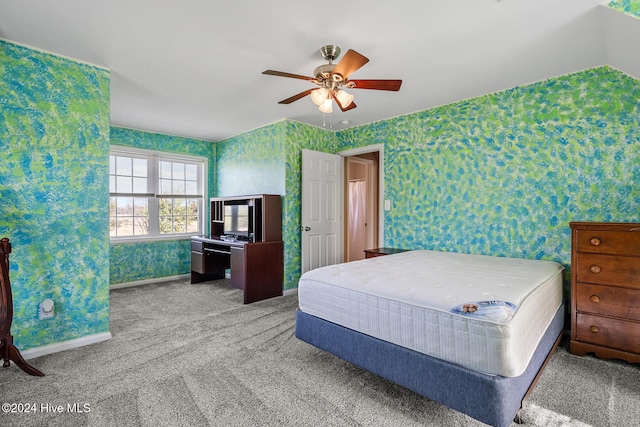 bedroom featuring vaulted ceiling, ceiling fan, and carpet floors