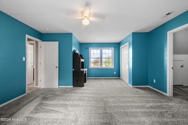 unfurnished bedroom with light colored carpet and ceiling fan