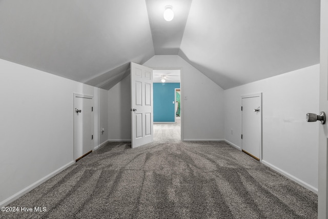 additional living space with carpet flooring, lofted ceiling, and ceiling fan