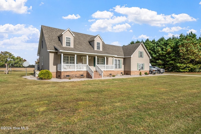 new england style home with a front yard and covered porch