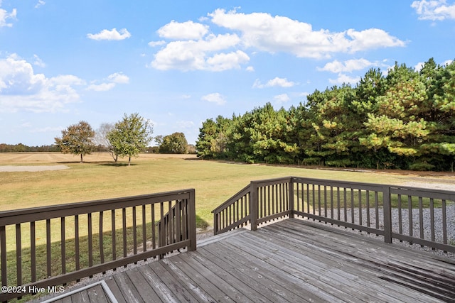 wooden deck with a lawn