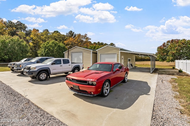 exterior space with a garage, a carport, and an outdoor structure