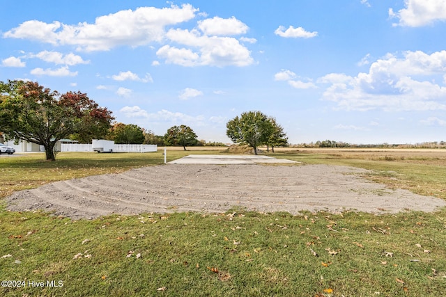 view of property's community with a lawn and a rural view