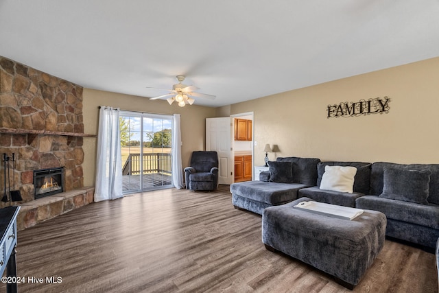 living room featuring hardwood / wood-style floors, a fireplace, and ceiling fan