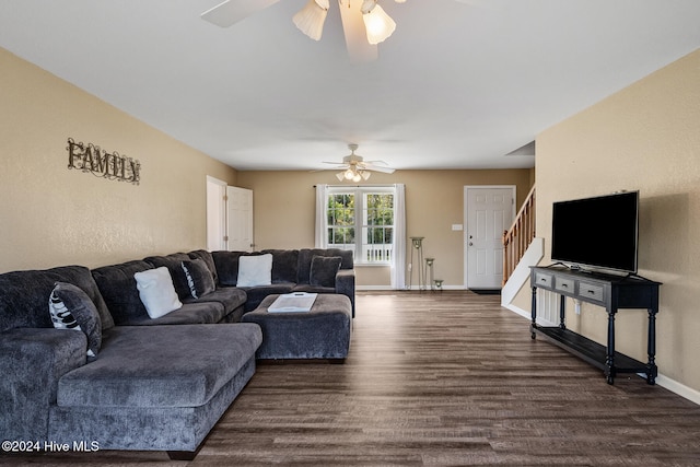 living room with dark wood-type flooring and ceiling fan