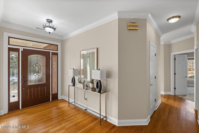 entryway with hardwood / wood-style floors and ornamental molding