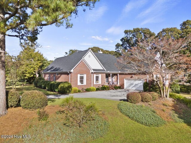 view of property featuring a garage and covered porch