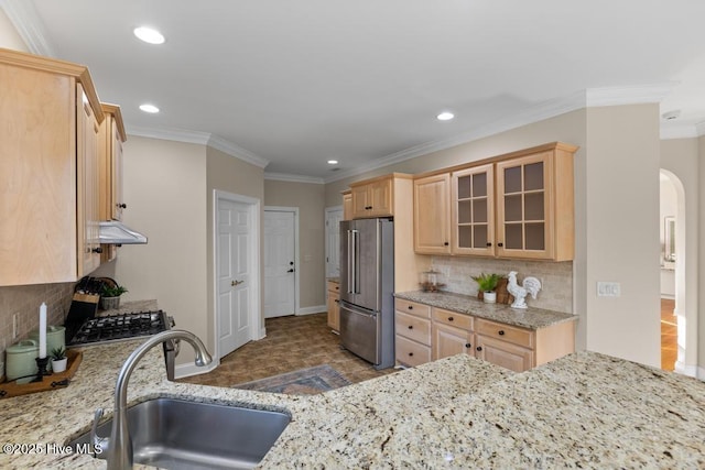 kitchen featuring sink, high end fridge, light stone counters, ornamental molding, and light brown cabinets