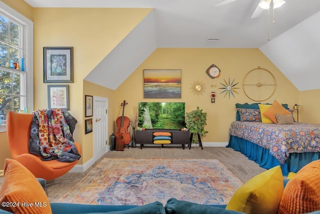 bedroom featuring ceiling fan, light colored carpet, and vaulted ceiling