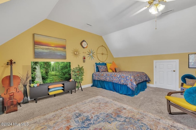 carpeted bedroom with ceiling fan and vaulted ceiling