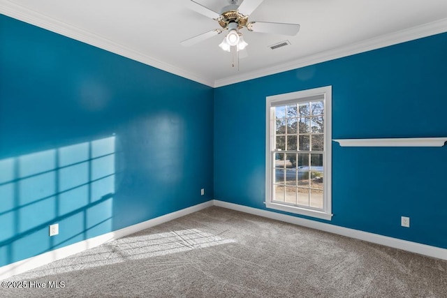 unfurnished room with ceiling fan, carpet, ornamental molding, visible vents, and baseboards
