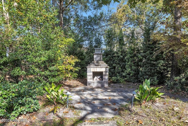 exterior space with a patio and an outdoor stone fireplace