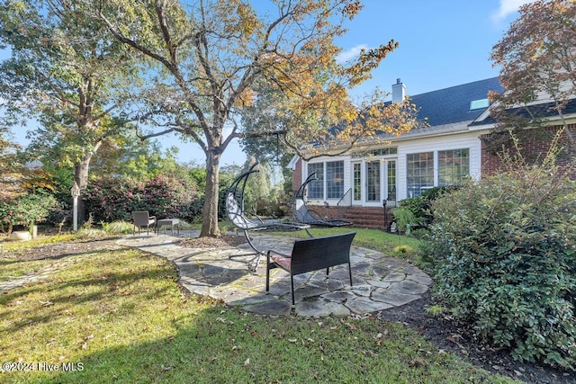 view of yard featuring a patio area and a sunroom