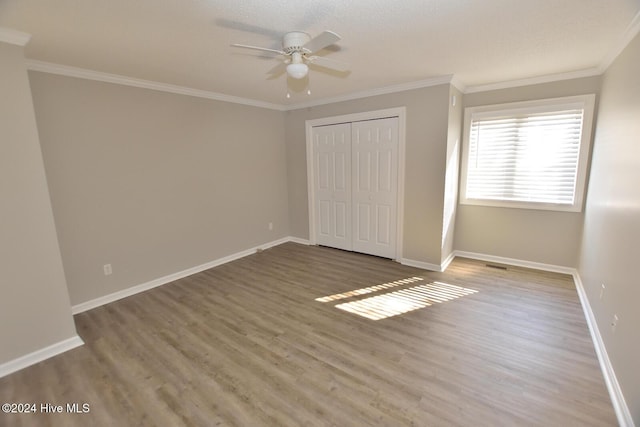 28 Winders Crk, Rocky Mount, NC 27804 - unfurnished bedroom with wood finished floors, baseboards, ornamental molding, a closet, and ceiling fan