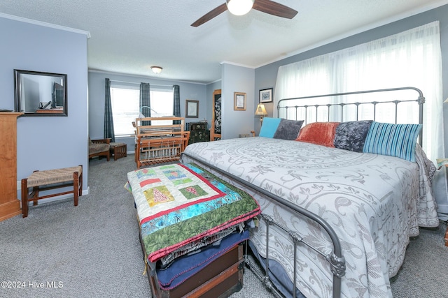 bedroom featuring crown molding, a textured ceiling, ceiling fan, and carpet flooring