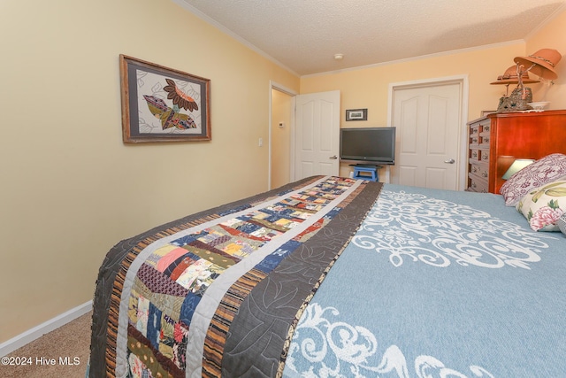 bedroom with ornamental molding, carpet flooring, and a textured ceiling