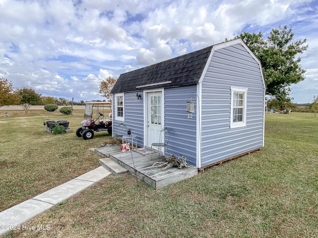 view of outbuilding featuring a yard