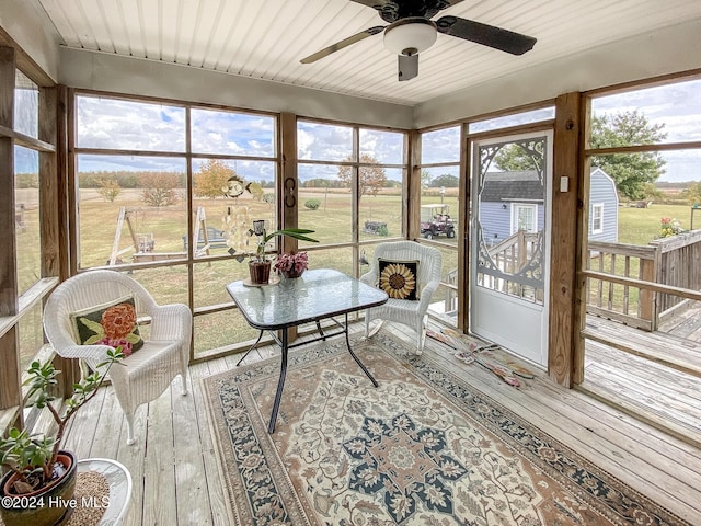 sunroom / solarium featuring ceiling fan and plenty of natural light