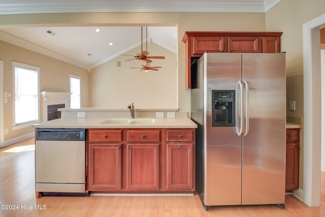 kitchen featuring sink, vaulted ceiling, ceiling fan, light hardwood / wood-style floors, and stainless steel appliances