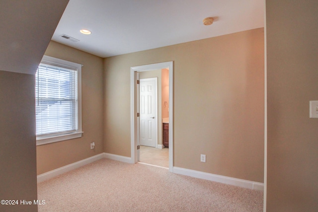 unfurnished bedroom with light carpet