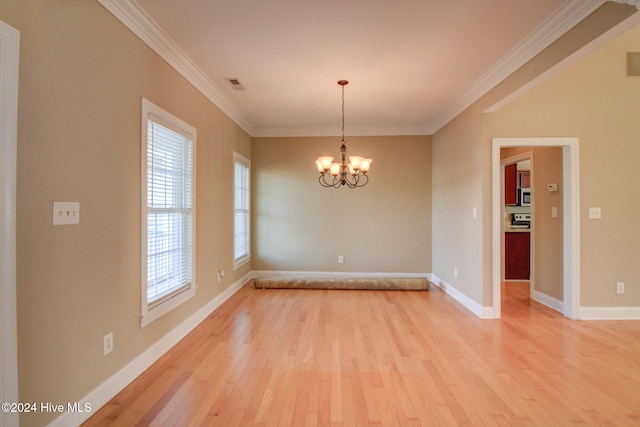 empty room with crown molding, a chandelier, and light wood-type flooring