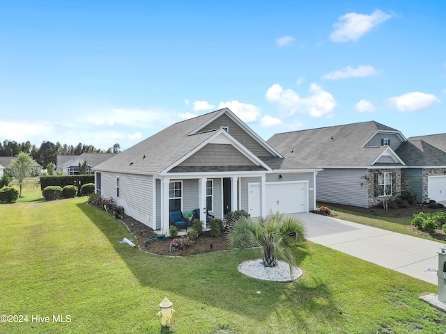 view of front of house with a front yard and a garage