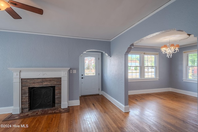 entrance foyer featuring wood-type flooring, ceiling fan with notable chandelier, and crown molding