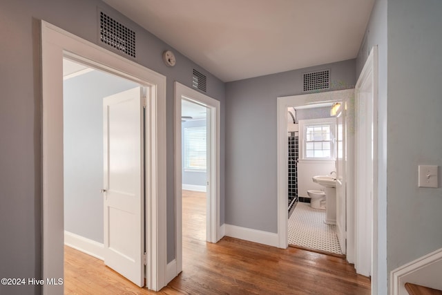 hall with hardwood / wood-style floors