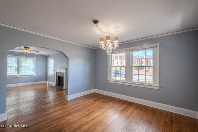 interior space with a wealth of natural light, wood-type flooring, and crown molding