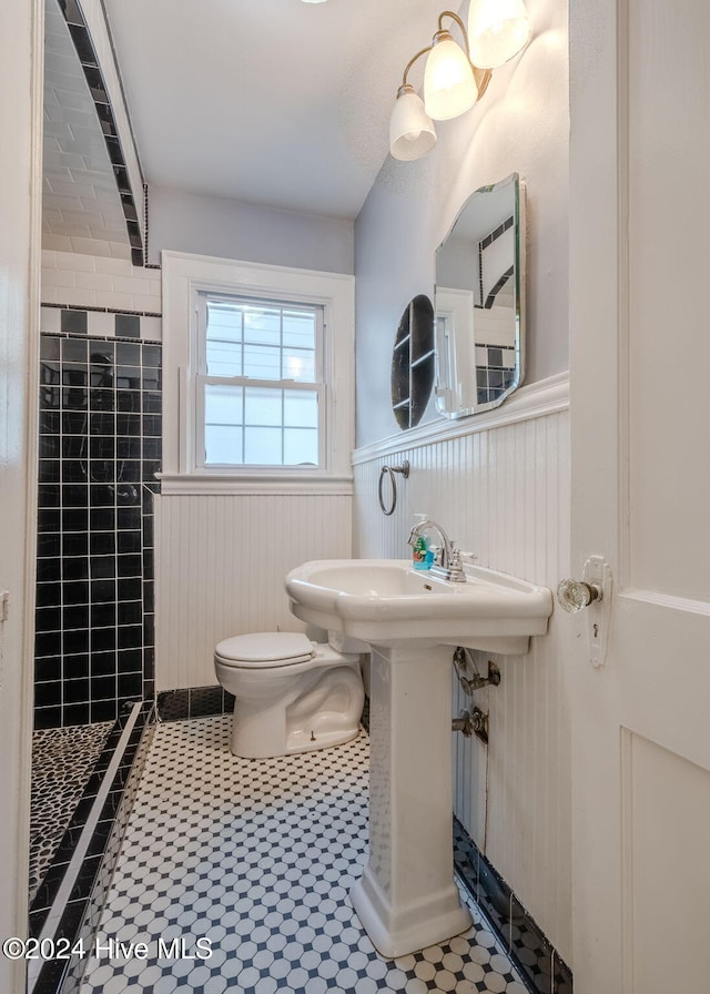 bathroom with toilet and tile patterned flooring