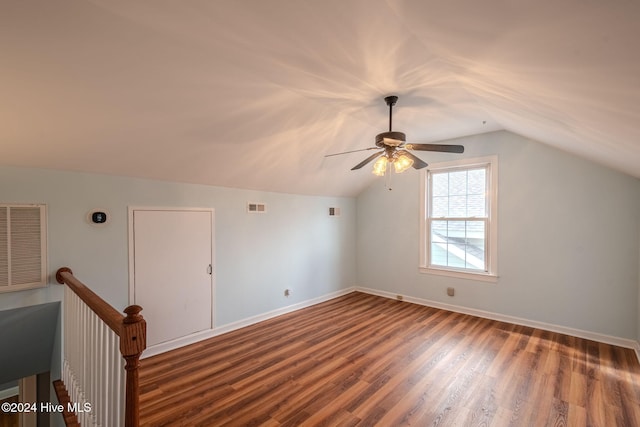 bonus room with dark hardwood / wood-style flooring, lofted ceiling, and ceiling fan