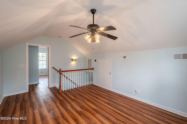 additional living space featuring dark hardwood / wood-style flooring, lofted ceiling, and ceiling fan