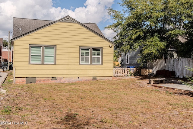 view of side of home with a lawn