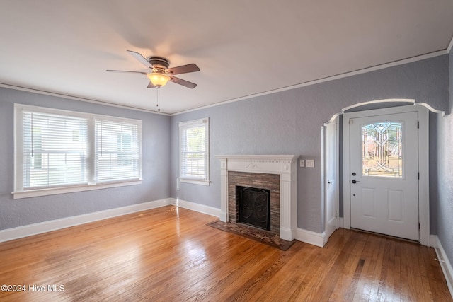 unfurnished living room featuring ceiling fan, light hardwood / wood-style flooring, and crown molding