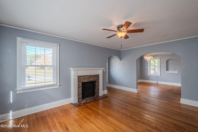 unfurnished living room with crown molding, wood-type flooring, a healthy amount of sunlight, and ceiling fan