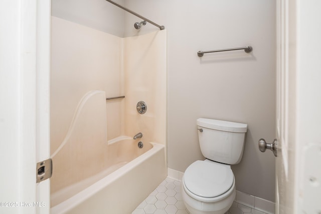 bathroom featuring shower / washtub combination, tile patterned flooring, toilet, and baseboards