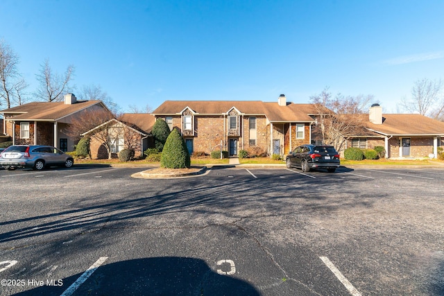 view of front of house with uncovered parking and a residential view